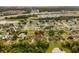 An aerial view showcases the neighborhood with mature trees, ponds, and nearby highway access, highlighting the home's location at 211 S Deerwood Ave, Orlando, FL 32825