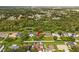 Aerial view of the property showcasing its location within a green, residential area at 211 S Deerwood Ave, Orlando, FL 32825