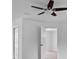 This bedroom features a ceiling fan and an open doorway to another room at 211 S Deerwood Ave, Orlando, FL 32825