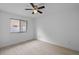 This bedroom features a ceiling fan and a window with a view of the neighborhood at 211 S Deerwood Ave, Orlando, FL 32825