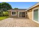 Brick patio with a sliding glass door offering seamless indoor-outdoor living at 211 S Deerwood Ave, Orlando, FL 32825