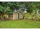 Backyard shed surrounded by mature trees at 211 S Deerwood Ave, Orlando, FL 32825