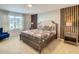 Inviting bedroom with a decorative accent wall, and a bright window with view at 2182 Cooper Bell Pl, Kissimmee, FL 34747