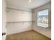 Walk-in closet with carpet flooring, a window, and wire shelving on all sides at 2182 Cooper Bell Pl, Kissimmee, FL 34747