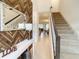 Inviting foyer with decorative wood wall, a stylish mirror, and carpeted stairs leading to the upper level at 2182 Cooper Bell Pl, Kissimmee, FL 34747