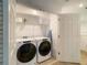 Laundry room with Whirlpool washer and dryer and a wire shelf at 2182 Cooper Bell Pl, Kissimmee, FL 34747