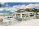 An outdoor bar at the community pool, with seating, umbrellas, and tables at 2182 Cooper Bell Pl, Kissimmee, FL 34747