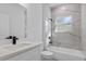 Bathroom featuring marble-look tile, a single-sink vanity, and a shower-tub combination, providing a luxurious and modern feel at 2249 Sw 146 Loop, Ocala, FL 34473