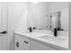 Bathroom with a dual-sink vanity, quartz countertops, and modern black fixtures, offering a sleek and stylish design at 2249 Sw 146 Loop, Ocala, FL 34473