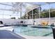 Enclosed pool area with a sunbathing chair, playset, and a shaded screen at 2324 Merrimack Dr, Kissimmee, FL 34743