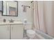 Well-lit bathroom with a sink, toilet, shower, and ample storage space at 2552 Woodgate Blvd # 204, Orlando, FL 32822