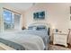 Tranquil bedroom with a cozy bed, white furniture, and a sunlit window at 2552 Woodgate Blvd # 204, Orlando, FL 32822