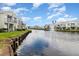 Waterfront homes with a central fountain as seen from across the canal at 2552 Woodgate Blvd # 204, Orlando, FL 32822