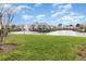 Community lake with fountain, manicured lawn, and lush greenery create a serene residential setting at 2552 Woodgate Blvd # 204, Orlando, FL 32822