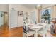 Bright dining room with white table and chairs, hardwood floors, and decorative lighting at 2552 Woodgate Blvd # 204, Orlando, FL 32822