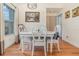 Comfortable dining area with wood floors, white furniture set, and natural light from nearby window at 2552 Woodgate Blvd # 204, Orlando, FL 32822