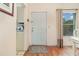 Welcoming entryway featuring wood floors, a white door, and a glimpse into the nearby kitchen at 2552 Woodgate Blvd # 204, Orlando, FL 32822