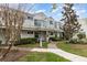 Inviting exterior view of condo featuring a balcony, well-maintained landscaping, and a charming walkway at 2552 Woodgate Blvd # 204, Orlando, FL 32822