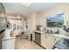 Cozy kitchen and dining nook with stainless steel appliances, a tile floor, and natural light at 2552 Woodgate Blvd # 204, Orlando, FL 32822