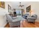 Comfortable living room showcasing plush seating, wood floors, ceiling fan, and a serene outdoor view at 2552 Woodgate Blvd # 204, Orlando, FL 32822