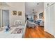 Open concept living and dining area with hardwood floors, furniture, and balcony access at 2552 Woodgate Blvd # 204, Orlando, FL 32822