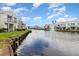 Scenic waterfront view of townhouses along a tranquil canal with a fountain and lush landscaping at 2552 Woodgate Blvd # 204, Orlando, FL 32822