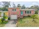 Charming single-story brick home with a well-maintained lawn, garage, and inviting blue front door at 256 Morningside Ave, Daytona Beach, FL 32118