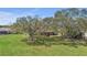 The large, lush backyard is accented by mature trees that offer plenty of shade at 2825 Lake Tohopekaliga Blvd, Kissimmee, FL 34746