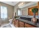 Well-lit bathroom features a granite countertop, modern backsplash, and vanity with wood cabinets at 2825 Lake Tohopekaliga Blvd, Kissimmee, FL 34746