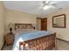 Cozy bedroom with ceiling fan, wood floors, and full-size bed with matching end tables at 2825 Lake Tohopekaliga Blvd, Kissimmee, FL 34746