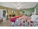 Bright bedroom featuring a queen-sized bed, access to the backyard, and an entertainment center with a television at 2825 Lake Tohopekaliga Blvd, Kissimmee, FL 34746