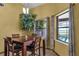 Bright and airy dining area with seating for four, a decorative tree, and a view of the pool at 2825 Lake Tohopekaliga Blvd, Kissimmee, FL 34746