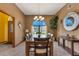 Elegant dining room featuring a wooden table, six chairs, a chandelier, and a view to the outside at 2825 Lake Tohopekaliga Blvd, Kissimmee, FL 34746