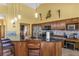 This kitchen features wood cabinets, stainless steel appliances, a breakfast bar, and a stylish mosaic backsplash at 2825 Lake Tohopekaliga Blvd, Kissimmee, FL 34746