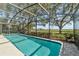 Inviting screened-in pool area with stunning backyard views and a serene ambiance at 2825 Lake Tohopekaliga Blvd, Kissimmee, FL 34746