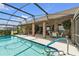 Screened-in pool area with a covered lanai and an outdoor dining space, perfect for entertaining at 2825 Lake Tohopekaliga Blvd, Kissimmee, FL 34746