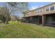 View of a back patio with screened in porch and green space at 2851 Polvadero Ln # 107, Orlando, FL 32835