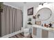 Charming bathroom with a decorative mirror, stylish vanity, and cozy shower curtain enhancing the room's appeal at 2851 Polvadero Ln # 107, Orlando, FL 32835