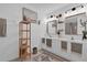 Bright bathroom with double vanity, modern mirrors, and a well-organized shelf creating a functional and stylish space at 2851 Polvadero Ln # 107, Orlando, FL 32835