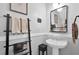 Stylish powder room featuring a modern vanity, mirror, decorative ladder, and elegant fixtures for guests' convenience at 2851 Polvadero Ln # 107, Orlando, FL 32835