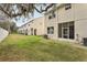 Townhome back facade showing a spacious yard and screened in back porch at 3167 Crown Jewel Ct, Winter Park, FL 32792