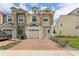 Charming townhome with a brick driveway and stone accents on the facade at 3167 Crown Jewel Ct, Winter Park, FL 32792