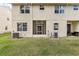 Exterior back view of a multi-story home showing the backyard and attached screened in porch at 3167 Crown Jewel Ct, Winter Park, FL 32792