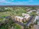 Stunning aerial view of the condo complex overlooking a lush green golf course and beautiful landscape at 325 Wilder Blvd # A404, Daytona Beach, FL 32114