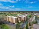 Beautiful aerial view of the condo complex with parking and a lush golf course in the background at 325 Wilder Blvd # A404, Daytona Beach, FL 32114