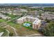 Scenic aerial view of the building with inviting pool, landscaping, parking and nearby golf course at 325 Wilder Blvd # A404, Daytona Beach, FL 32114