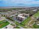 Aerial view showcases building, parking and green spaces in a serene location near a scenic waterway at 325 Wilder Blvd # A404, Daytona Beach, FL 32114