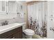 Clean bathroom with vanity, butterfly shower curtain, cabinet and neutral walls at 325 Wilder Blvd # A404, Daytona Beach, FL 32114