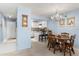 Cozy dining room with table, chairs, chandelier, and access to the modern kitchen at 325 Wilder Blvd # A404, Daytona Beach, FL 32114