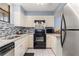 Well-lit kitchen with stainless steel appliances, tile backsplash, and modern cabinetry at 325 Wilder Blvd # A404, Daytona Beach, FL 32114